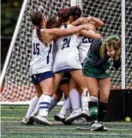  ?? MARK STOCKWELL FOR THE GLOBE ?? Walpole celebrated after Kate Schneider connected in double overtime for a 1-0 Division 1 victory over Bishop Feehan.