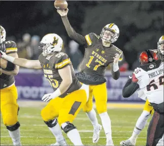  ?? Michael Smith ?? The Associated Press Wyoming quarterbac­k Josh Allen, passing against San Diego State during a 2016 Mountain West game in Laramie, Wyo., will have the national spotlight on him to start this season following a campaign in which he passed for 3,203 yards...