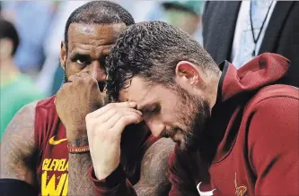  ?? MADDIE MEYER GETTY IMAGES ?? LeBron James, left, and Kevin Love of the Cleveland Cavaliers react on the bench in the second half against the Celtics during Game 2 of the NBA Eastern Conference finals at TD Garden in Boston on Tuesday.