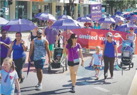  ?? Picture: PATRINA MALONE ?? Supporters of Internatio­nal Women's Day march through Darwin's streets to raise awareness of the plight of women across the globe