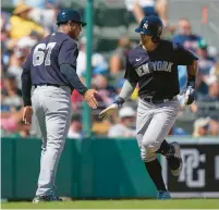  ?? ?? The Yankees’ Anthony Volpe is greeted by third base coach Luis Rojas (67) on his solo homer in the fifth inning of Sunday’s spring training game against the Boston Red Sox in Fort Myers, Fla.