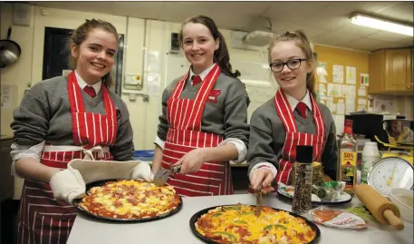  ??  ?? Students preparing food dishes for their home economics class.