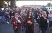  ?? MACOMB DAILY FILE PHOTO ?? Attendees last year walk with their candles behind Fishbone’s Rhythm
Cafe in St. Clair Shores to honor the memory of Jared Glenn.