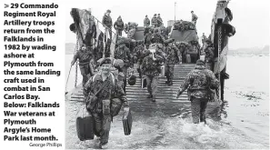  ?? George Phillips ?? 29 Commando Regiment Royal Artillery troops return from the Falklands in
1982 by wading ashore at Plymouth from the same landing craft used in combat in San Carlos Bay. Below: Falklands War veterans at Plymouth Argyle’s Home Park last month.