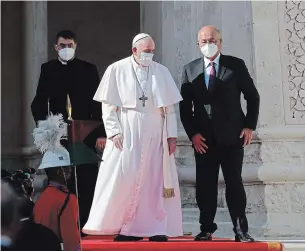  ?? ANDREW MEDICHINI THE ASSOCIATED PRESS ?? Pope Francis is welcomed by Iraqi President Barham Salih at Baghdad’s Presidenti­al Palace on Friday in the pontiff’s first trip abroad since the coronaviru­s pandemic began.