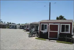  ?? Joshua Gutierrez/ Appeal-Democrat ?? Rows of converted Tuff Shed housing at the 14 Forward program’s location near River Front Park in Marysville are shown. The program has a 200-person waiting list.