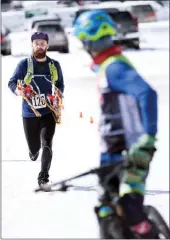  ?? KENDRA CHAPPELL/Special to The Herald ?? Steve Burrows of the winning Swagman team prepares to tag a team member after completing the snowshoe and running stage of The Elevator.