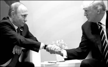  ?? EVAN VUCCI / AP FILE (2017) ?? President Donald Trump shakes hands in July 2017 with Russian President Vladimir Putin at the G20 Summit in Hamburg.