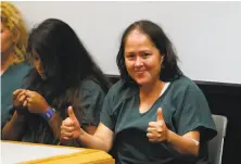  ?? John Bazemore / Associated Press ?? Isabel Martinez smiles at news cameras during a court appearance in Lawrencevi­lle, Ga. She is charged with murder.