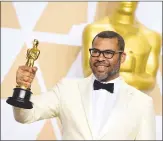  ??  ?? Jordan Peele, winner of the award for best original screenplay for “Get Out”, poses in the press room.