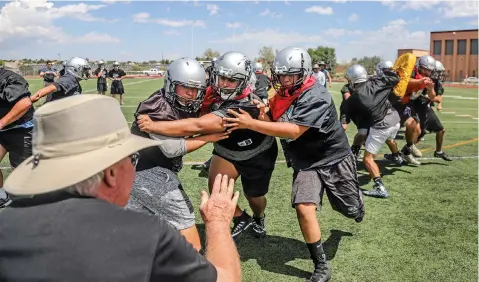  ?? PHOTOS BY GABRIELA CAMPOS/THE NEW MEXICAN ?? Head football coach Bill Moon oversees the Jaguars’ first day of official preseason workouts Monday at Capital High School. The Jaguars’ season opener is set for Aug. 24 against Pojoaque Valley.