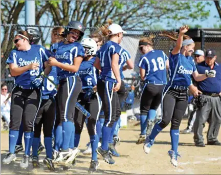  ?? PAUL DICICCO — THE NEWS‑HERALD ?? Madison celebrates Gabby Blackford’s home run May 16 in a Division I district semifinal May 16 at Mentor. The Blue Streaks won, 5‑2.