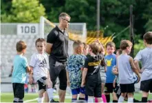  ?? Pittsburgh Riverhound­s ?? Mike Whiteman works with elementary school kids in the Riverhound­s Academy’s Grassroots program in summer 2022.