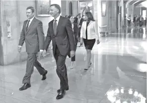  ?? SHELLEY MAYS/THE TENNESSEAN ?? Gov.-elect Bill Lee and his wife, Maria, and Gov.r Bill Haslam and his wife, Crissy, walk together to a joint news conference Wednesday at the Tennessee State Capitol.