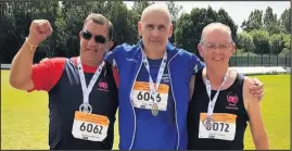  ??  ?? ■ Shepshed’s John Mould (centre) at the 5K race walk medal presentati­on.