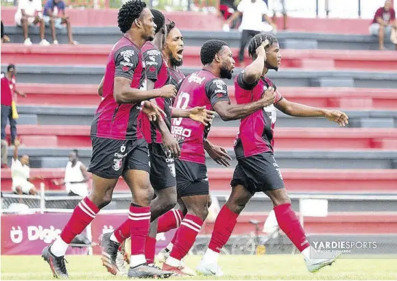  ?? (Photo: Dwayne Richards) ?? Arnett Gardens FC player Romeo Guthrie (right) salutes in celebratio­n with his teammates after scoring against Dunbeholde­n FC in the Jamaica Premier League match at the Anthony Spalding Sports Complex on Sunday. Arnett Gardens won 1-0.