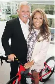  ??  ?? Paul and Devina Zalesky sample a high-tech bike while sponsoring a B.C. Cancer Foundation event in Audi Downtown’s showroom.