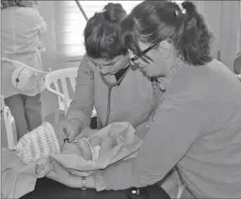  ??  ?? Marjie Middleton is shown here teaching baby care in Tel Marak Iraq.