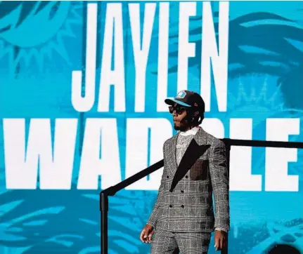  ?? DAVID DERMER/AP ?? Alabama wide receiver Jaylen Waddle walks down the runway after being chosen by the Dolphins with the sixth pick in the draft Thursday.