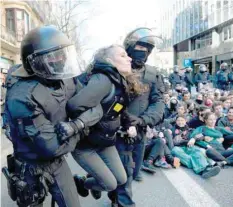  ??  ?? Catalan regional police forces Mossos d’esquadra disperse students blocking a street in Barcelona. — AFP
