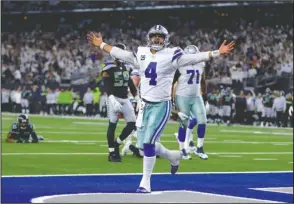  ?? The Associated Press ?? PRIME TIME: Dallas quarterbac­k Dak Prescott celebrates a first-down run a week ago in the fourth quarter of the Cowboys’ 24-22 home victory against the Seattle Seahawks in Arlington, Texas, during the wild-card round of the NFL playoffs.