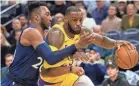  ?? BRAD REMPEL/USA TODAY SPORTS ?? Lakers forward LeBron James tries to drive on Timberwolv­es guard Josh Okogie.