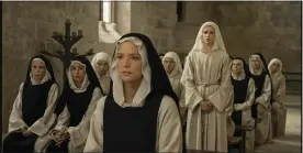  ?? IFC FILMS VIA AP ?? This image released by IFC Films shows Daphne Patakia, standing background, and Virginie Efira in a scene from “Benedetta.”