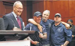  ?? Mark Wilson / Getty Images ?? With Sen. Chuck Schumer, left, overlookin­g the scene, Jon Stewart embraces John Feal, second from left, and a member of the Feal Good Foundation.