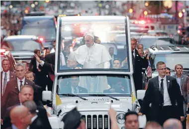  ?? Photo: REUTERS ?? Pope Francis waves to the crowds as he is driven down Fifth Avenue in the Popemobile at the start of his visit to New York.