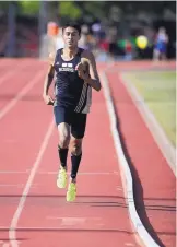  ??  ?? Hobbs’ Andrew Bosquez cruises to victory in the boys 1,600-meter run on Monday at the Marilyn Sepulveda Meet of Champions.