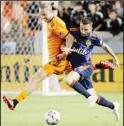  ?? ?? Houston Dynamo midfielder Griffin Dorsey (25) and Seattle Sounders forward Nicolas Benezet (20) become entangled while chasing the ball during the first half of an MLS soccer match, on Oct. 16, in Houston. (AP)