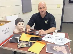  ?? COURTESY KAREN MINTZ ?? Orange County, North Carolina, Sheriffs Department Major Tim Horne and items from the Boy Under the Billboard case.