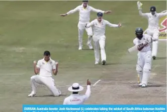  ??  ?? DURBAN: Australia bowler Josh Hazlewood (L) celebrates taking the wicket of South Africa batsman Hashim Amla (R) during the fourth day of the first Test cricket match between South Africa and Australia at The Kingsmead Stadium in Durban yesterday. — AFP