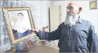  ?? ?? Otabek’s father Abdumannon Sattoriy shows a portrait of his son during an interview with AFP in his house in Termez, some 800 kms from Tashkent.