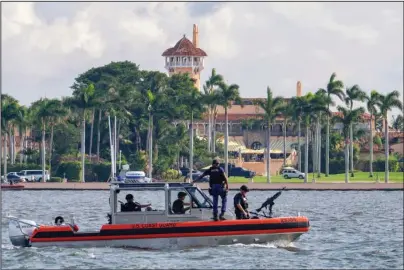  ?? The Associated Press ?? PATROL BOAT: In this Nov. 22, 2018, file photo, a U.S. Coast Guard patrol boat passes President Donald Trump’s Mar-a-Lago estate in Palm Beach, Fla. Trump’s expected move to his Mar-a-Lago club after he leaves office next month is being challenged by a lawyer who says a 1990s agreement allowing Trump to convert the property into a business prohibits anyone from living there, including him.