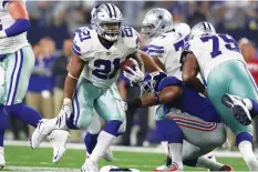  ?? (Reuters) ?? IT WAS just another 100-yard game for Ezekiel Elliott (21), who ran like a carefree Dallas Cowboys rusher on Sunday night and not the polarizing player who is facing potential suspension from the NFL. Elliott suited up for the Cowboys’ season-opening...