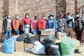  ??  ?? GIVING BACK: Members of the Saps Women s Network and Men for Change visited Gali Thembani Youth Centre on Wednesday to donate clothes Picture: NTSIKELELO QOYO