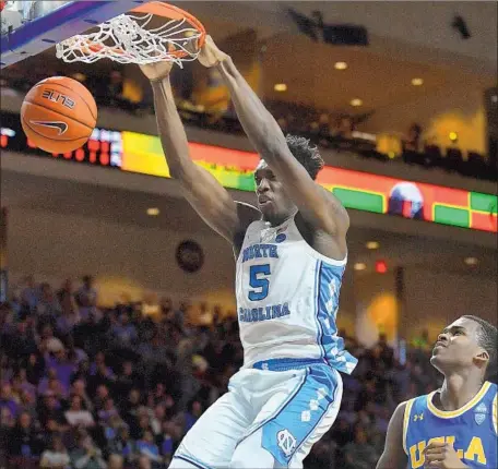  ?? Sam Wasson Getty Images ?? NASSIR LITTLE, dunking over UCLA’s Kris Wilkes last season, f loundered at North Carolina. His father says had the Historical Basketball League been an option at the time, “I would seriously consider it, knowing the things I know and the experience we had.”