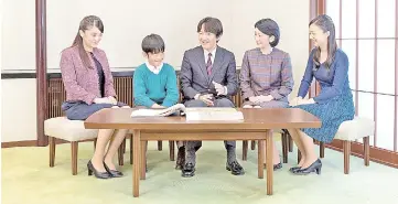  ??  ?? Prince Akishino (centre) talks with his wife Princess Kiko (second right) and their children, Mako (left), Kako (right) and Hisahito at their residence in Tokyo. — Reuters photo