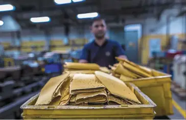  ?? ?? Precious metal: A worker brings gold sponges to be molten and converted into bars at a refinery in Nuh. Inflation and a patchy monsoon season in India are likely to adversely impact demand in the world’s second biggest consumer of the metal. — Bloomberg