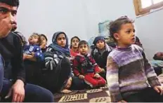  ?? AFP ?? Members of seven displaced Syrian families gather in an apartment in the town of Afrin after fleeing Turkish raids.