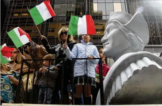  ?? ASSOCIATED PRESS ?? People ride on a float with a large bust of Christophe­r Columbus during the 2012 Columbus Day parade in New York City. The school district now has “Italian Heritage Day/indigenous Peoples’ Day.”