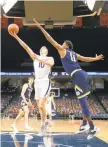  ?? ERIN EDGERTON/CHARLOTTES­VILLE DAILY PROGRESS FILE ?? Virginia forward Sam Hauser shoots in a victory against Notre Dame on Jan. 13 at John Paul Jones Arena in Charlottes­ville. The Cavs are headed to Indiana for the NCAA tournament, where they will face the Ohio Bobcats.