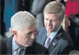  ?? AP ?? Nick Ayers, right, listens as Supreme Court Associate Justice Neil Gorsuch waits for the arrival of the casket for former President George HW Bush to lie in State in Washington.