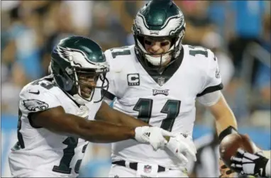  ?? BOB LEVERONE — THE ASSOCIATED PRESS ?? The Eagles’ Nelson Agholor (13) celebrates his touchdown catch against the Panthers with quarterbac­k Carson Wentz (11) in the second half Thursday in Charlotte, N.C.