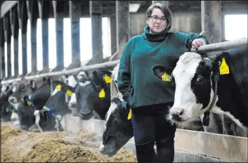  ?? Robert F. Bukaty The Associated Press ?? Jenni Tilton-flood in a dairy barn at Flood Brothers Farm in March in Clinton, Maine. Foreign-born workers make up half of the farm’s staff of nearly 50.