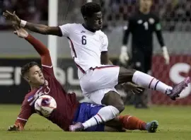  ?? Moises Castillo, The Associated Press ?? Costa Rica's Brandon Aguilera, below, and United States' Yunus Musah battle for the ball during a World Cup qualifier in San Jose, Costa Rica, on Wednesday.