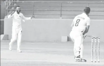  ??  ?? THE MOMENT! In this Romario Samaroo photo, Veerasammy Permaul downplays taking his 500th first class wicket.