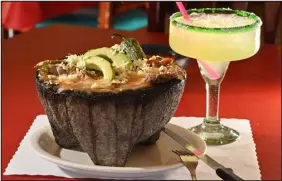  ?? HYOUNG CHANG — THE DENVER POST ?? Molcajete Tierra and a Margarita at Los Arcos in Westminste­r on Jan. 10. Steak, chicken, pork and cheese are served with the volcanic stone.