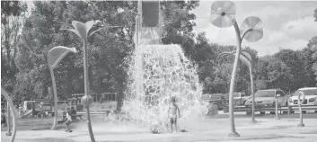  ?? [VERONICA REINER / THE OBSERVER] ?? Children were happy to be completely soaked at the Bolender Park splash pad on August 16. The facility uses an average of 258 cubic metres of water per day.